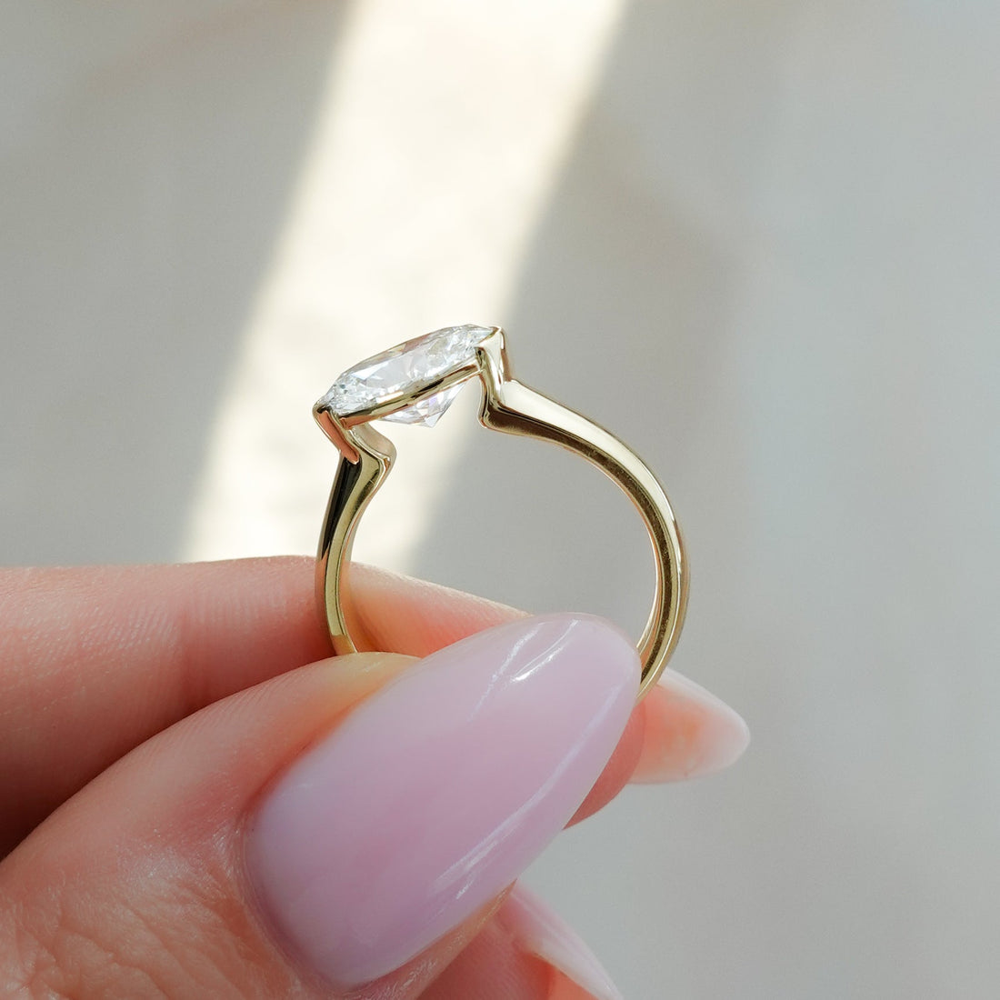 East West Half Bezel 4mm Solitaire Engagement Ring With Oval Cut Diamond