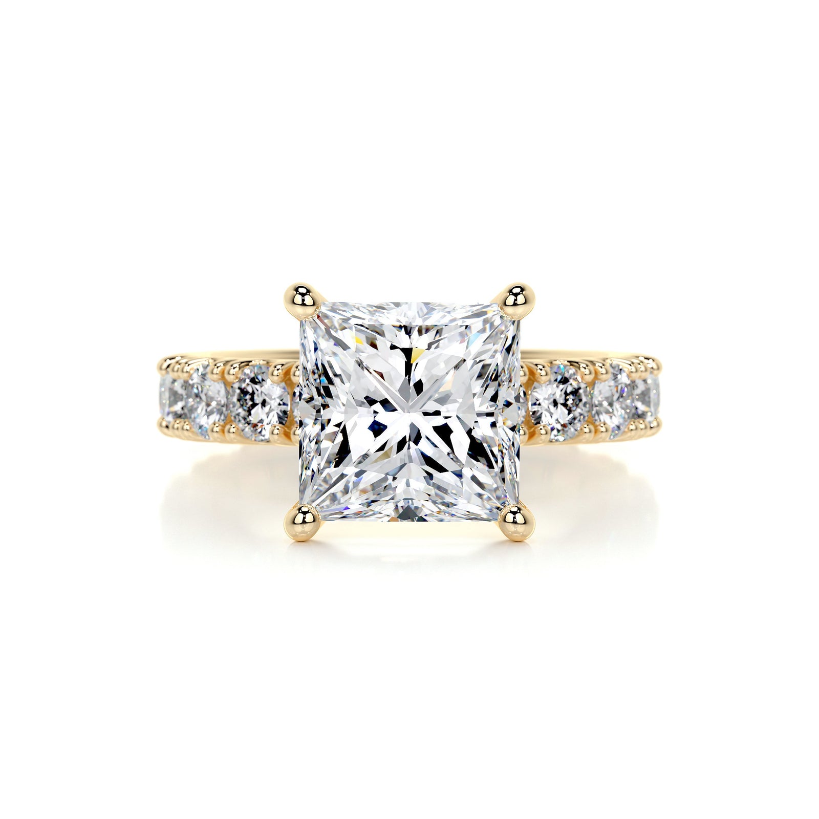 A princess cut diamond pavé engagement ring with gold band and round moissanite side stones