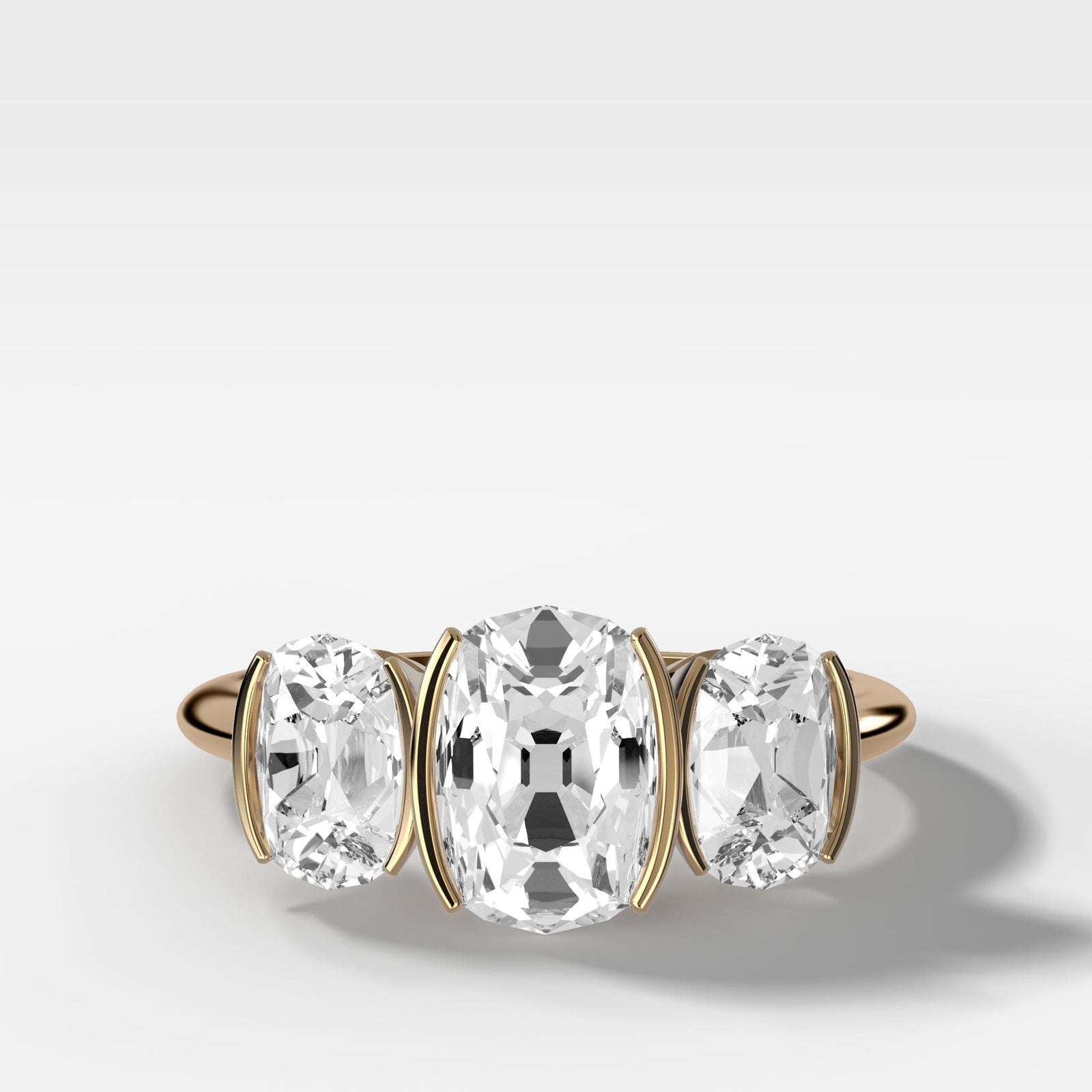 elongated-old-mine-cut-three-stone-ring-half-bezel